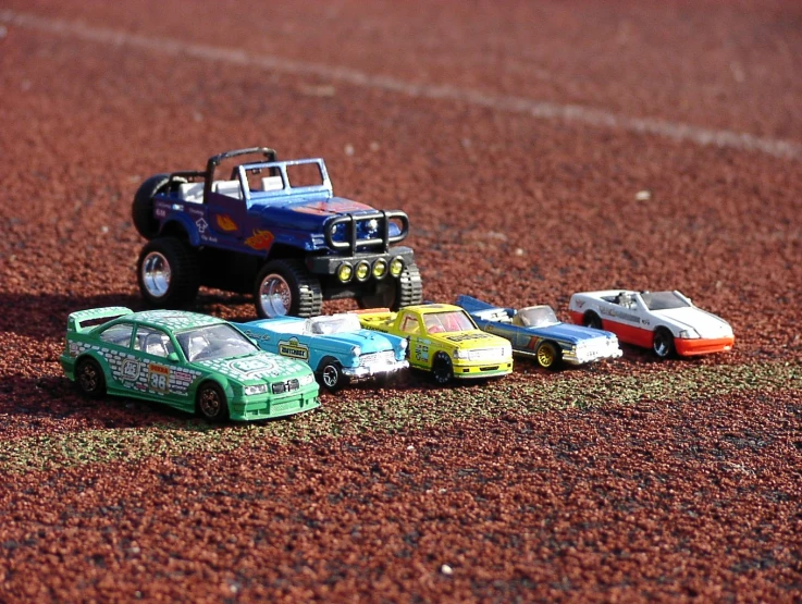 there is a bunch of toy cars that are on the ground