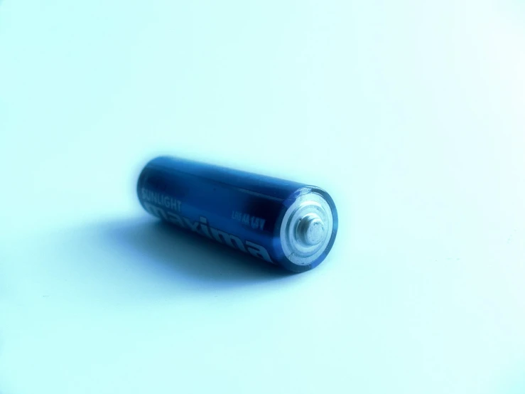 a blue batteries on a white surface