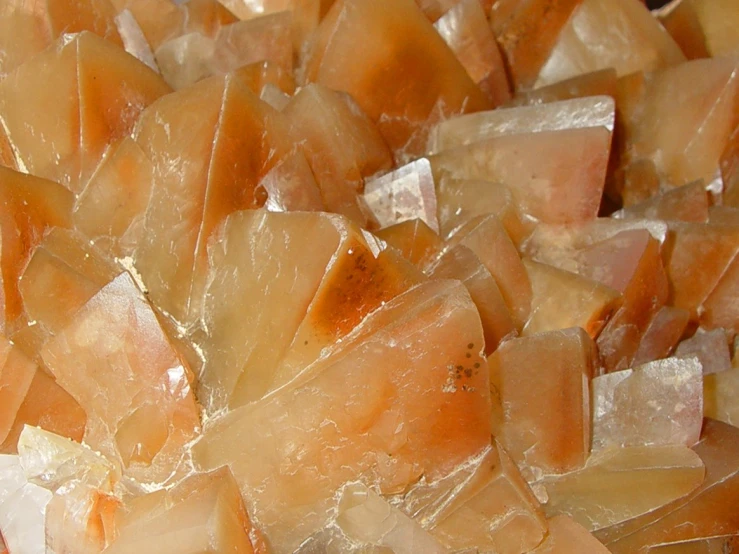 a pile of raw orange and white sugar crystals