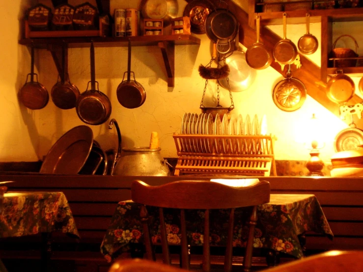 a chair and table with cooking utensils on the wall