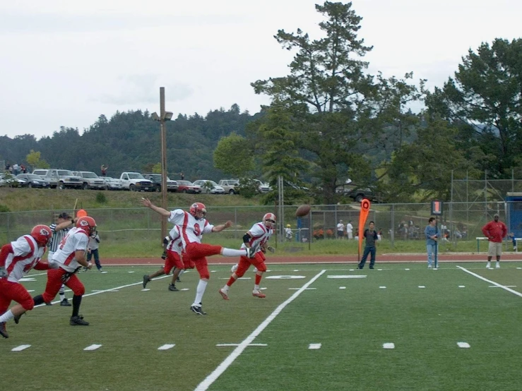 a football game in progress with the players running and throwing