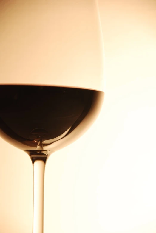 wine glass on a table with the reflection of a light