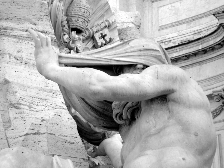 the statue is beside a building with a clock