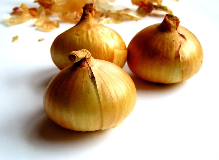 three onions are arranged near the whole one