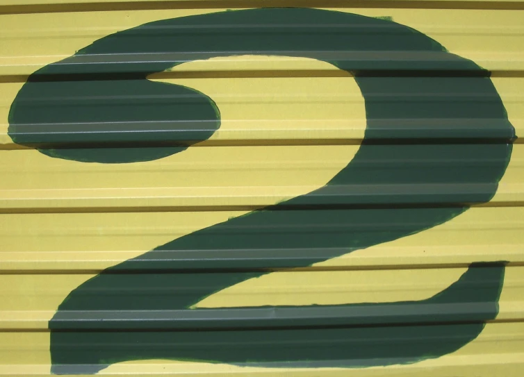a sign that reads number two next to a yellow and blue building