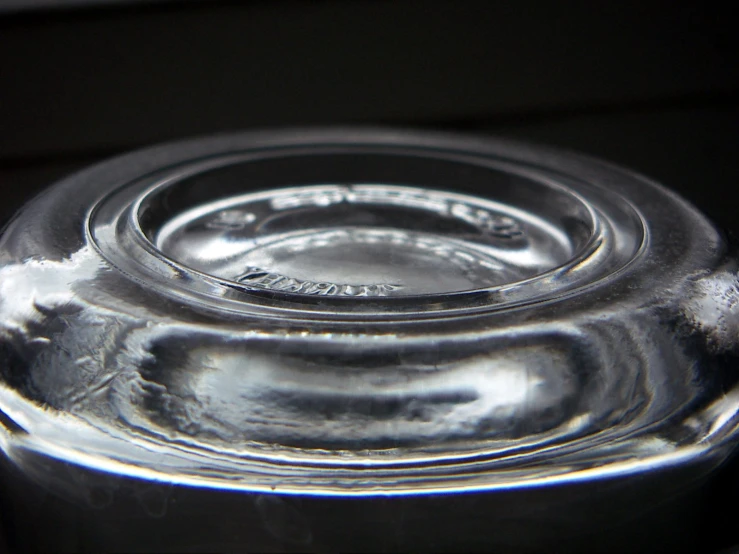 an empty clear jar with lid on a table