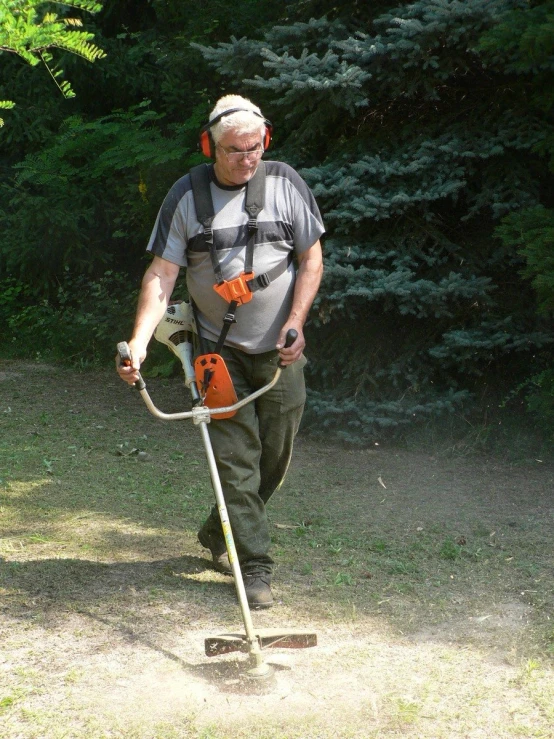 a man standing with a cordless tool