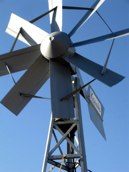 a white windmill with an arrow pointing to the left