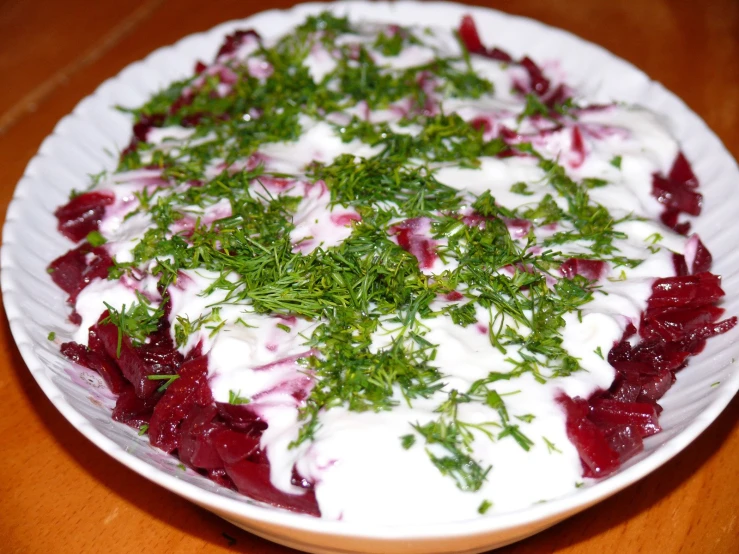 a plate with cranberry sauce and herbs