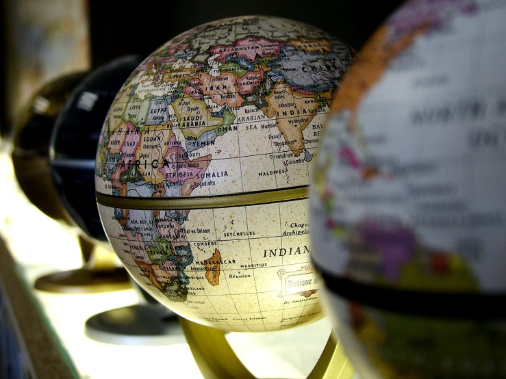 two globes, one is shown in three different countries