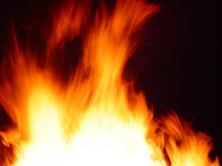a fire is burning against a black background