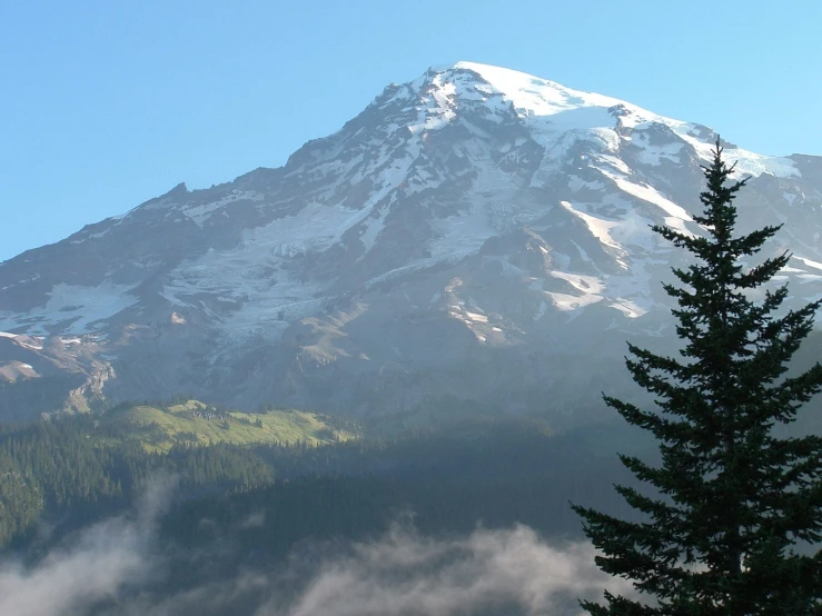 a view of a mountain and tree line at dusk