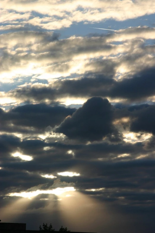 a sky filled with clouds and sun rays