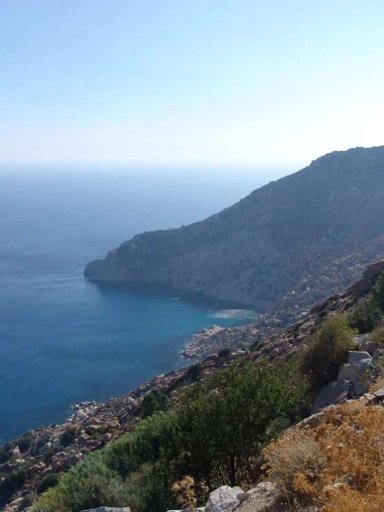 a mountain with a body of water and buildings