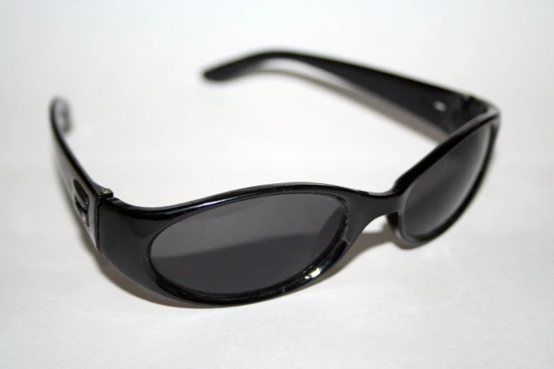 black sunglasses on a table with one pair of glasses in focus