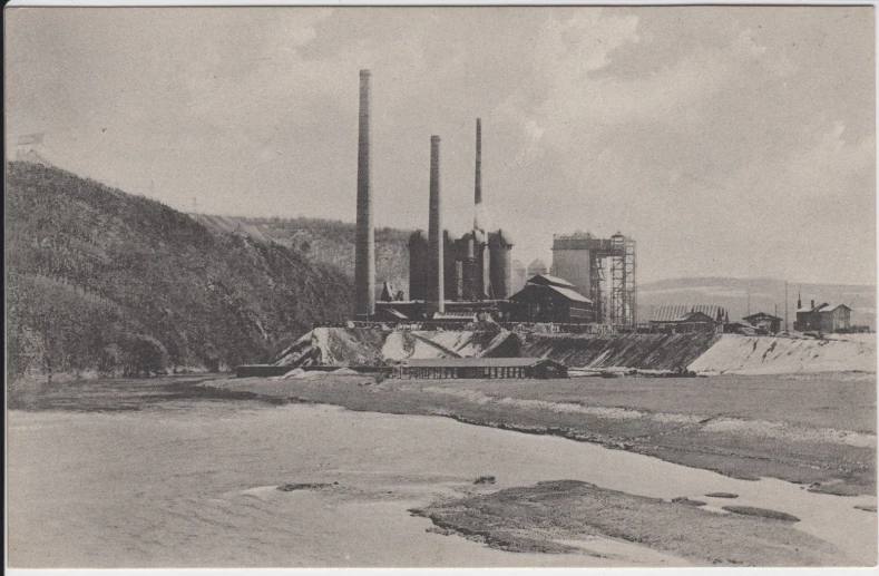 a drawing of industrial buildings and a body of water