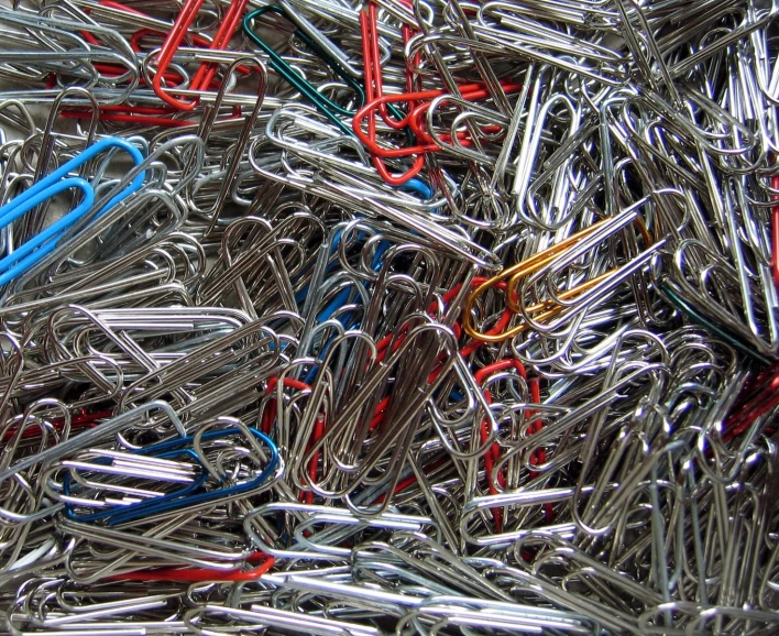a bunch of colorful paper clip laying together