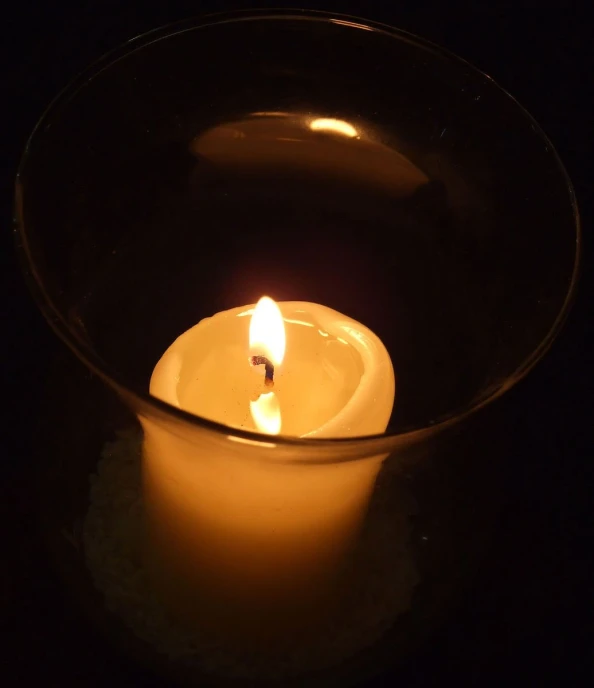 the candle is glowing in the dark