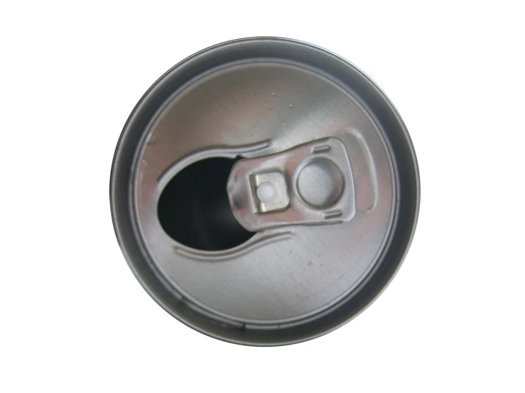 a soda can lid sitting on a white surface