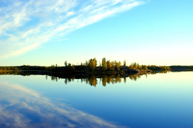 the sky is reflecting on the water and clouds