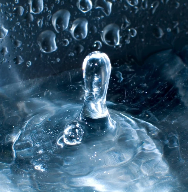 the water is being poured on top of a plastic bowl