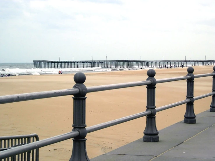 a person walking on the boardwalk near the water