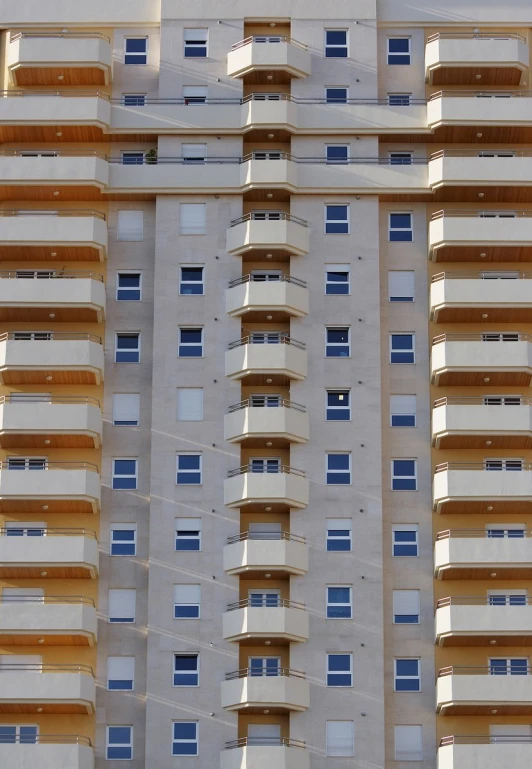 a large building with balconies against a light colored sky