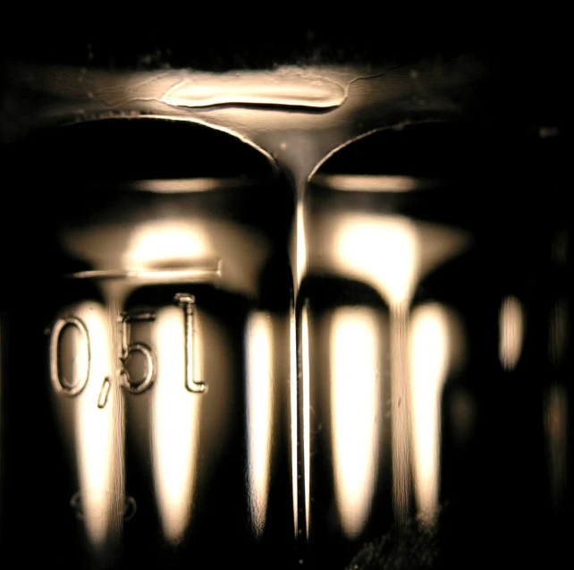 a dark room with three shiny metal objects