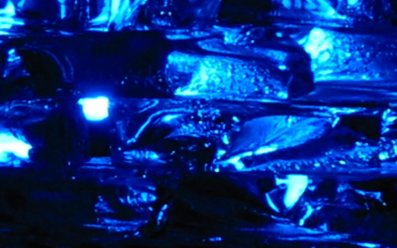 a group of vases are lit up with blue lighting