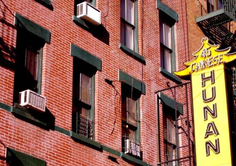 the sign is yellow for humans on a building