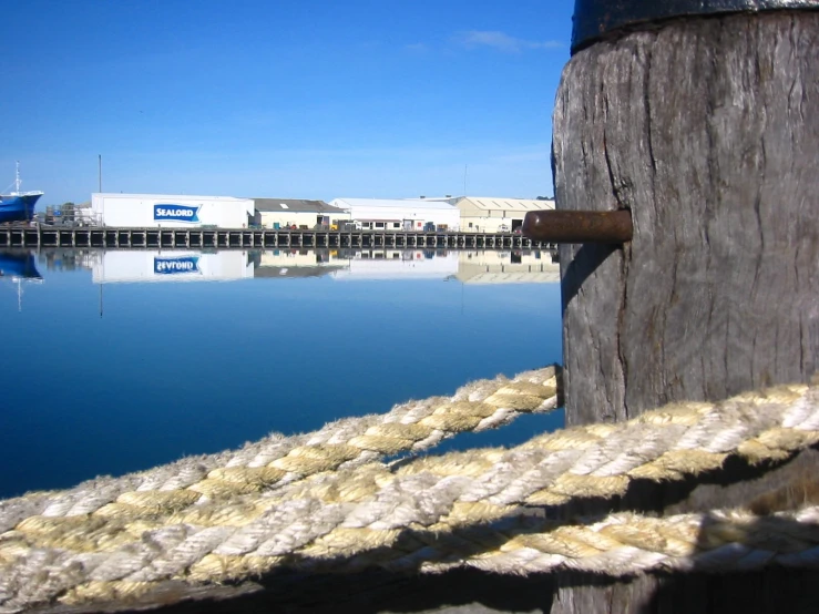 a pole on a dock with a rope