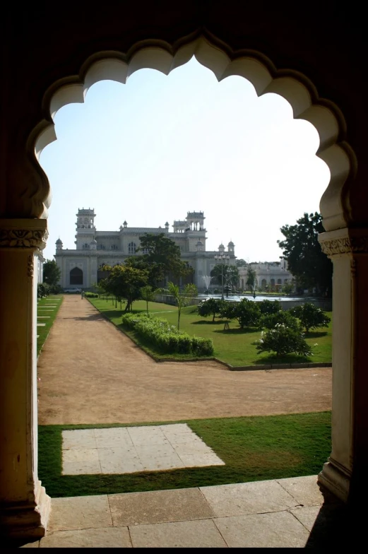 view from a stone archway on a grassy area near the walkway