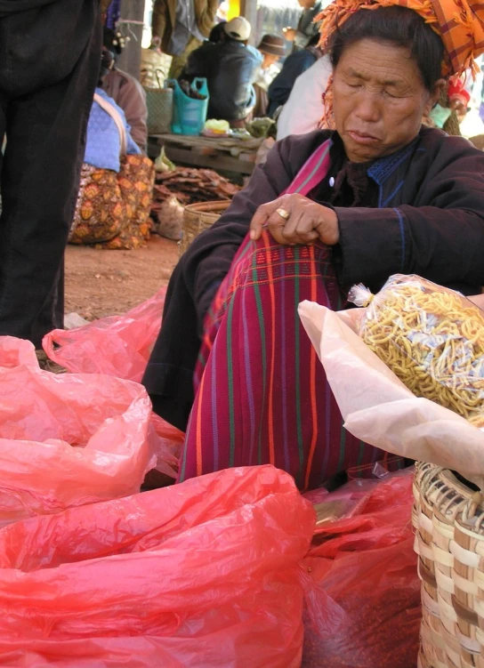 an image of woman selling food on a street