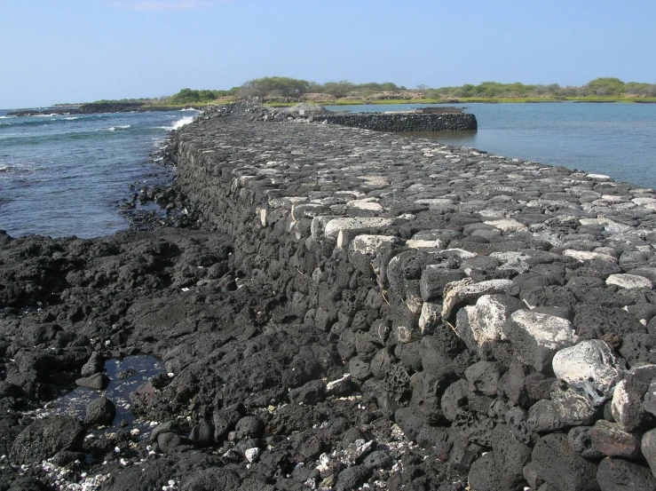 the ocean wall is covered in many rocks