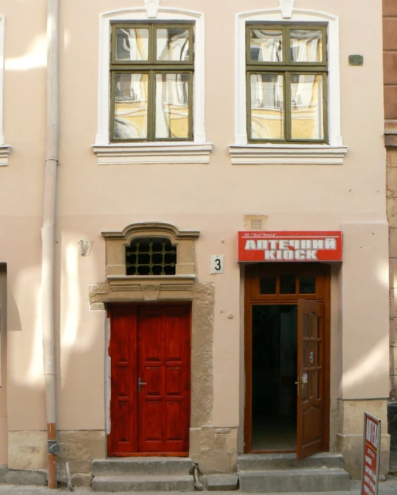 an old fashioned red door on an older style building