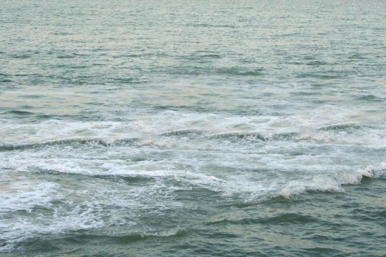 people on surf boards in the ocean near shore