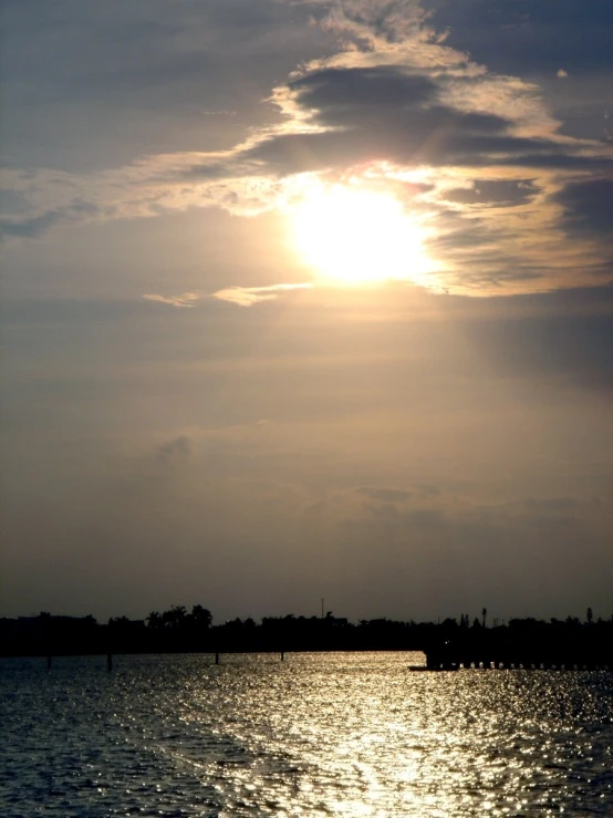 a person riding a boat under a cloudy sky