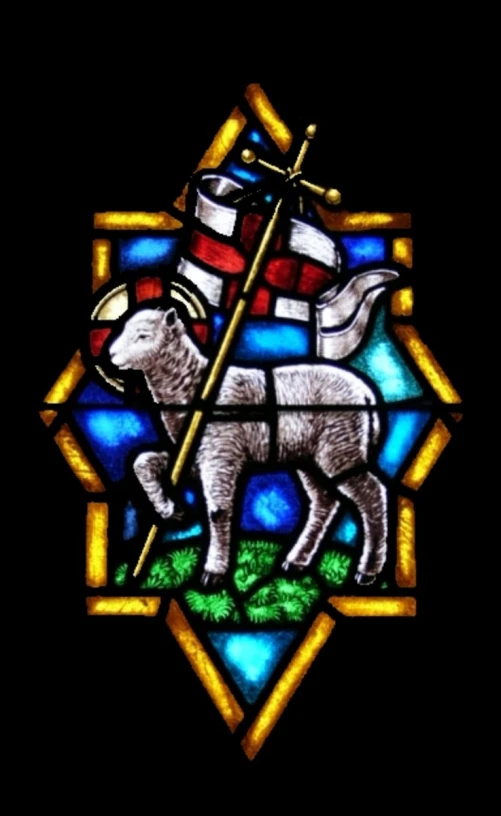 a stained glass window with an animal and cross