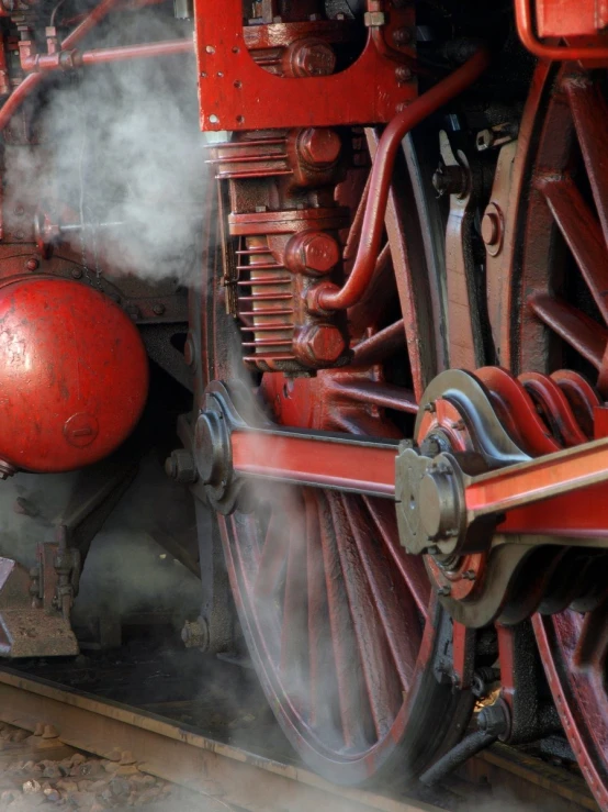 steam pouring out from a machine wheel and creating steam