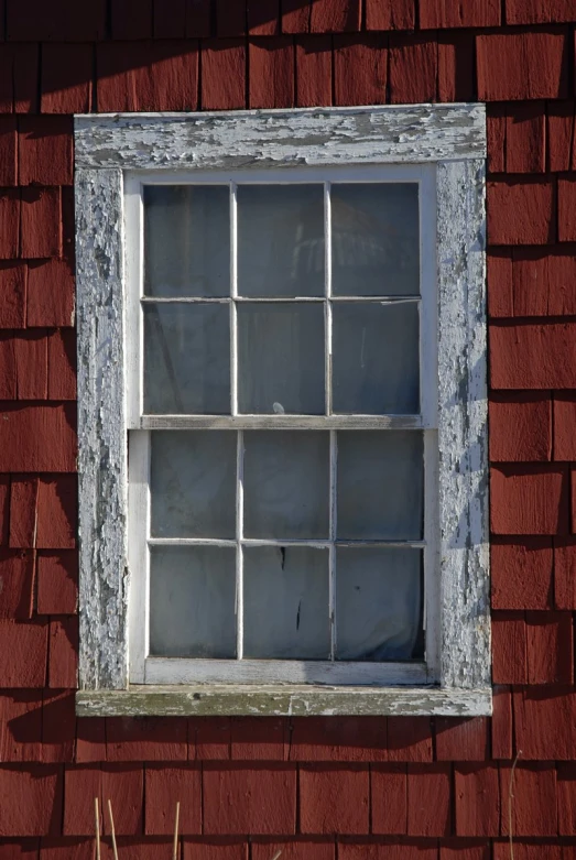 an old window of a brick building with no glass