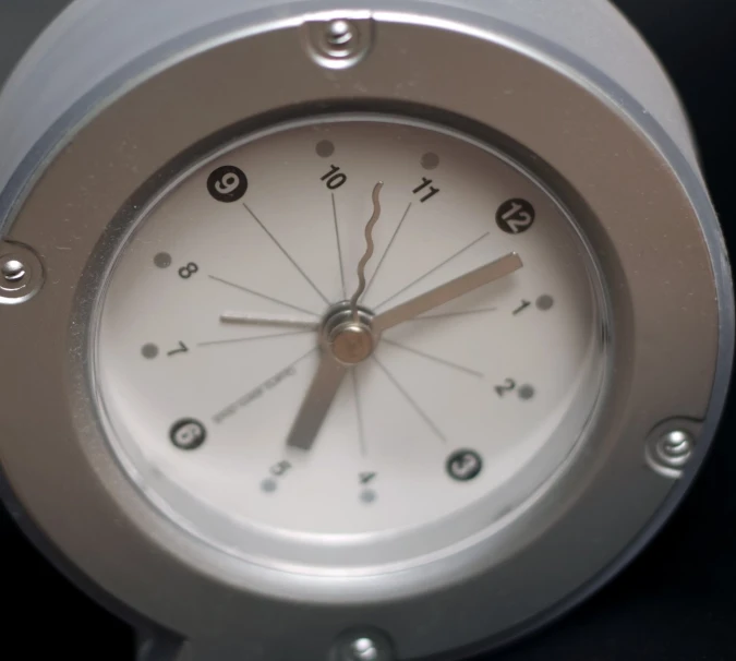 a clock that is white and silver in color