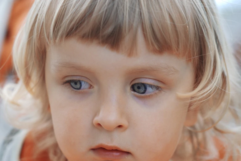 this is a picture of a little girl wearing big blue eyes