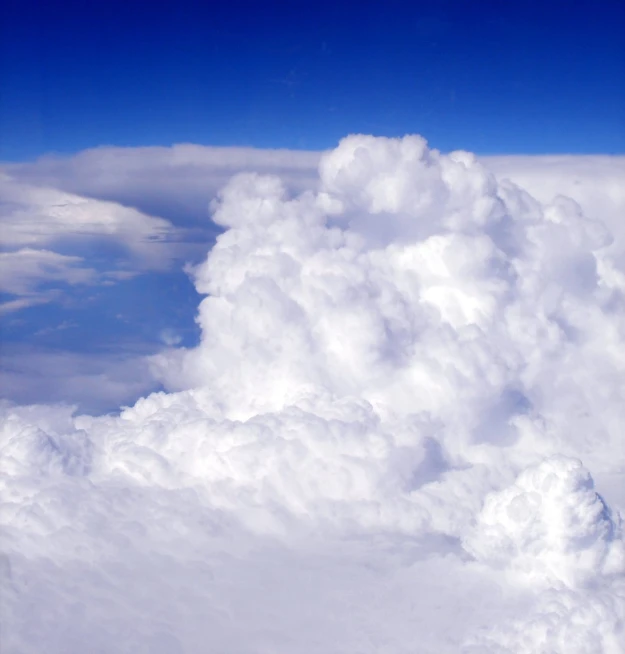 an airplane flying through the clouds as it passes