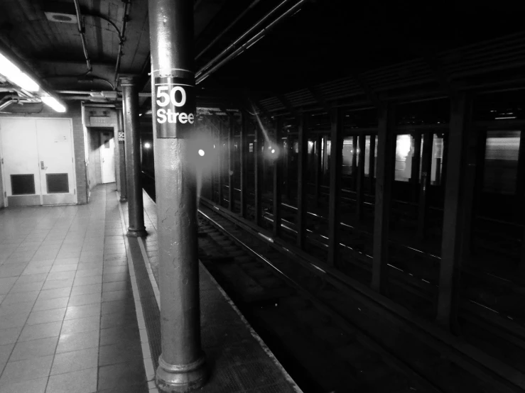 a black and white po shows a subway station