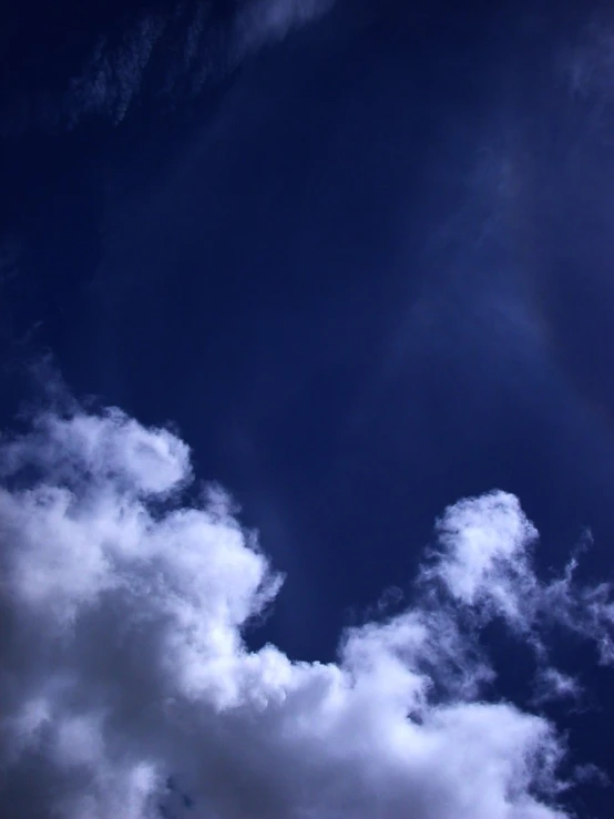 a sky with some clouds and a plane