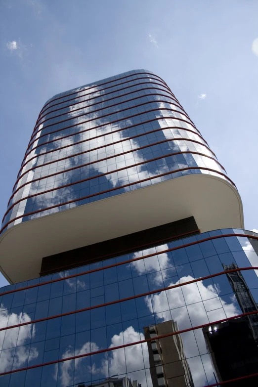 an upward view of a building with reflections from the windows