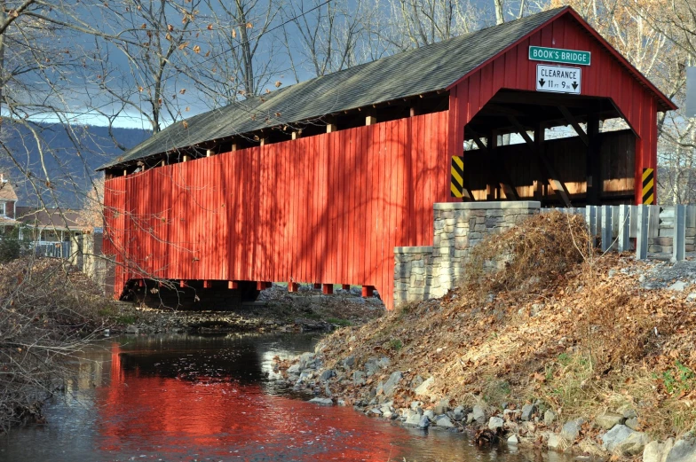 the underside of a covered bridge spanning a river
