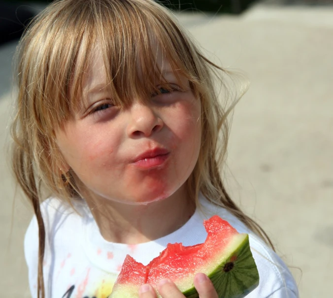 the  is eating a piece of watermelon