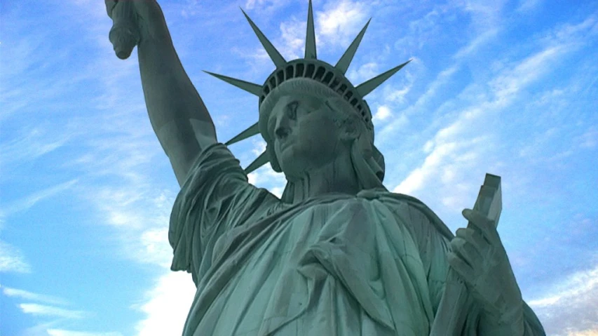 the statue of liberty holding a phone on her right arm