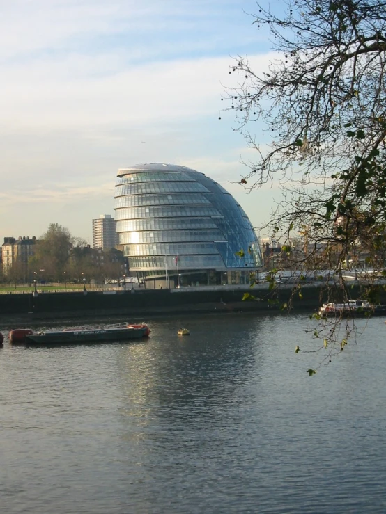 a boat is on the river outside a large building